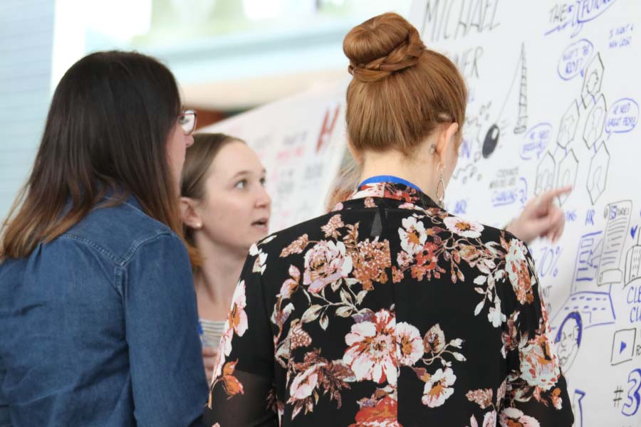 attendees-looking-at-whiteboard attendees-looking-at-whiteboard